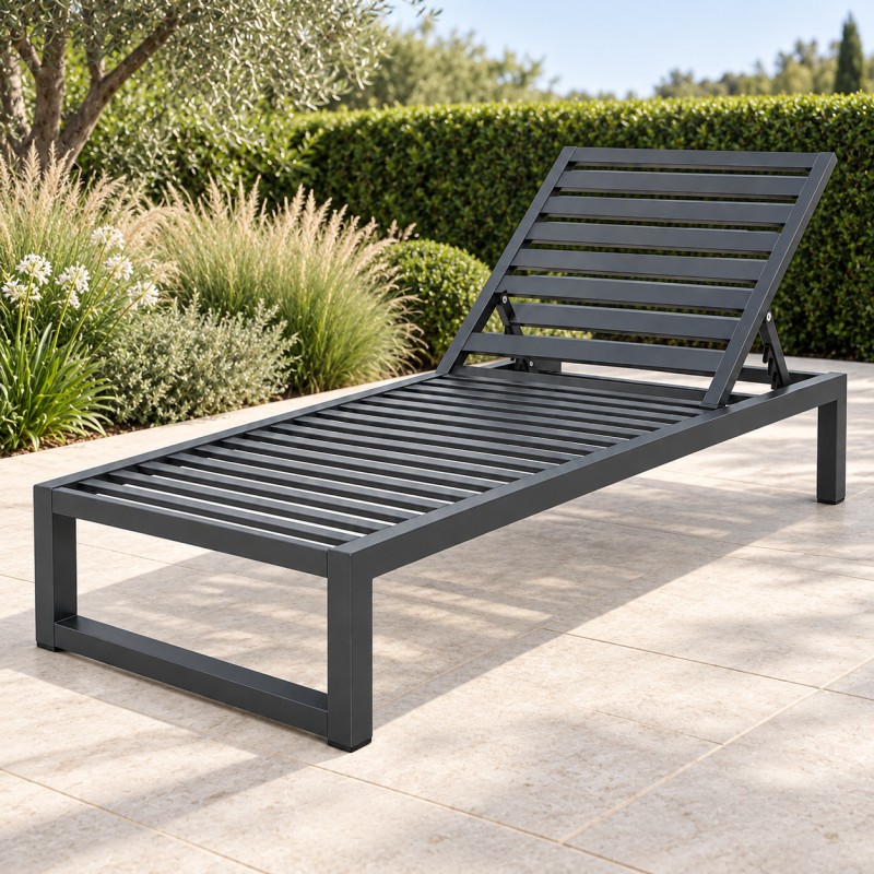 Garden lounger with adjustable backrest on a stone patio beside garden planting