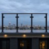 Glass Balcony Railing, on a roof terrace with a city skyline at dusk