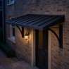 Steel Entrance Canopy, over the door of a brick house in the evening